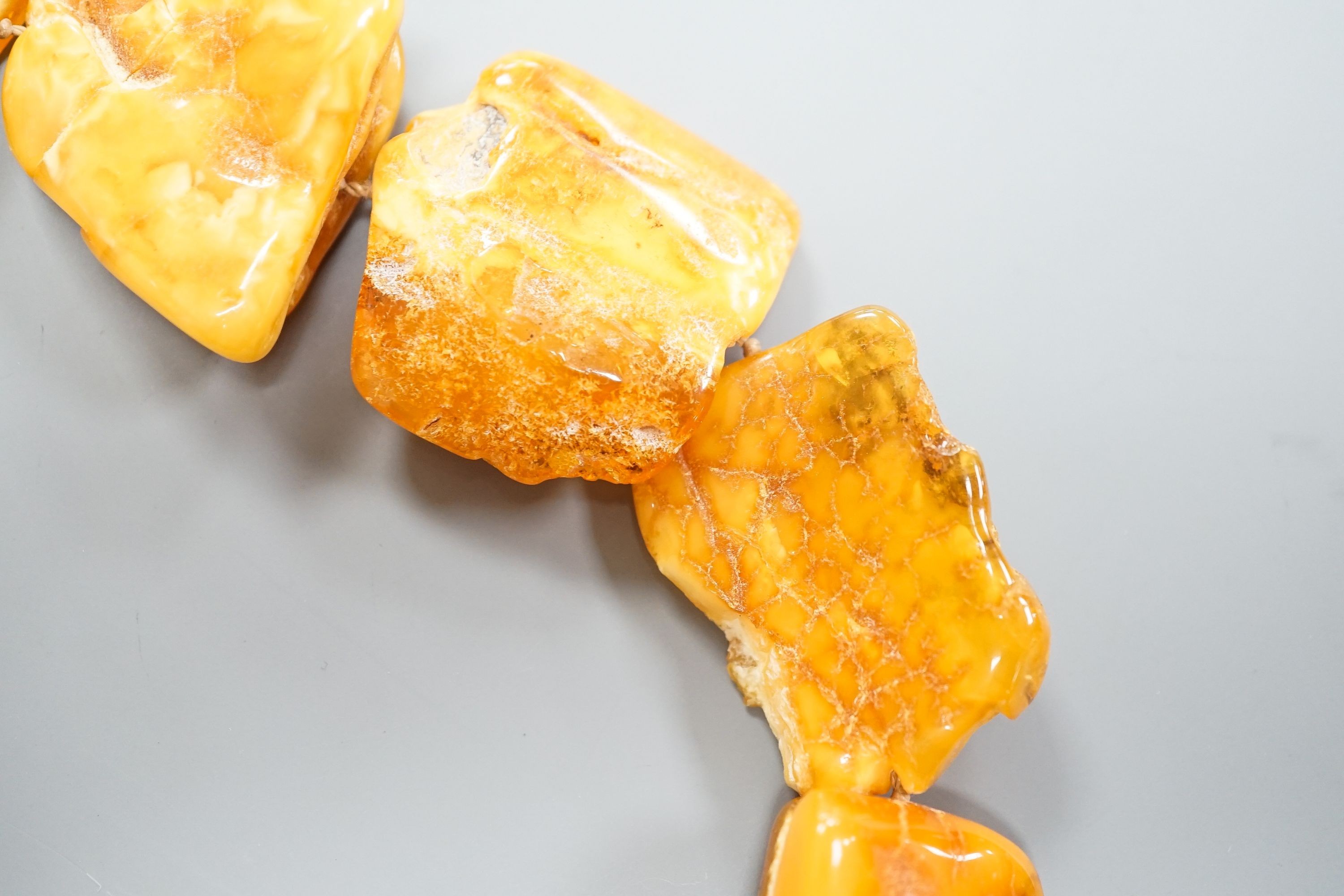 A graduated amber pebble necklace, 56cm gross weight 79 grams, (a.f.).